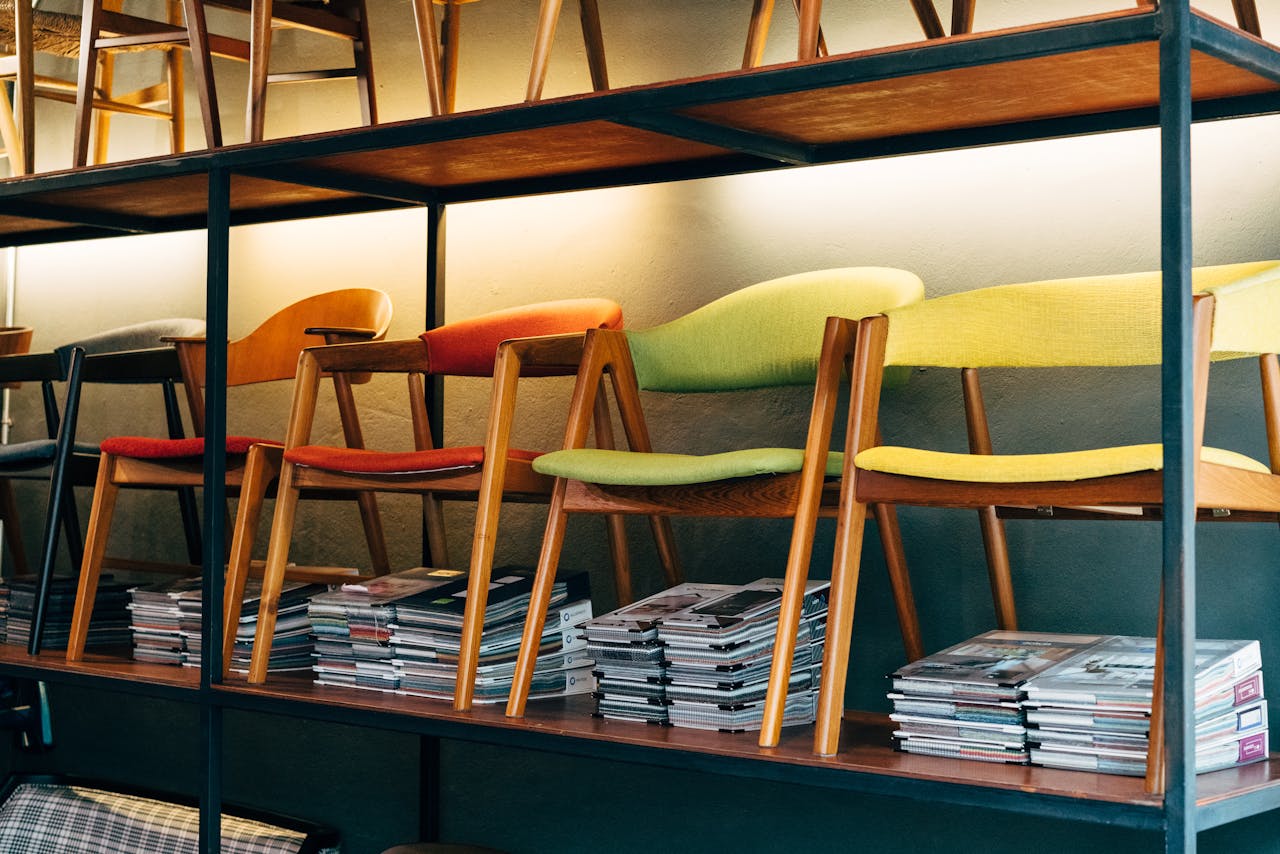 Vibrant modern wooden chairs arranged on shelves in a stylish furniture store display.